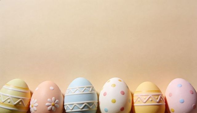 Colorful pastel Easter eggs on soft beige background with floral dots and stripes
