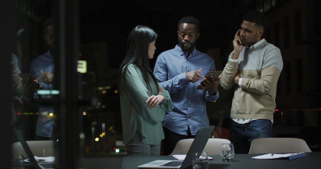 Focused Business Team Discussing Strategy in Modern Office at Night - Download Free Stock Images Pikwizard.com