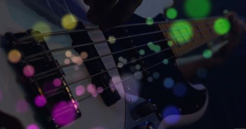 Bassist Performing on Stage with Colorful Lights