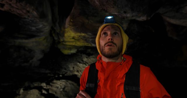 Man Exploring Dark Cave Wearing Headlamp and Red Jacket - Download Free Stock Images Pikwizard.com