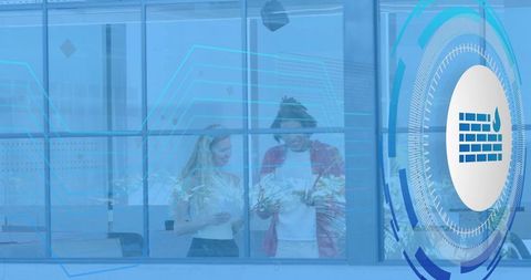Colleagues Examining Office Plants Behind Glass with Digital HUD Firewall Overlay