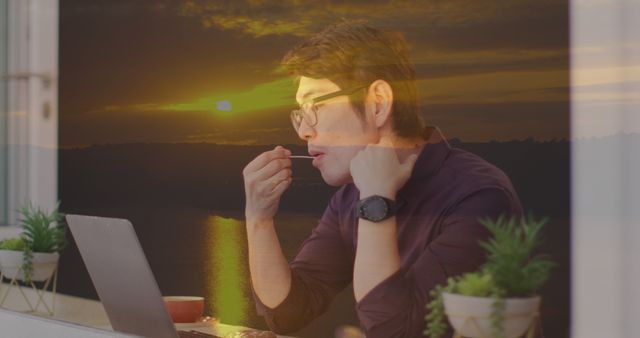 Man Having Snack While Working on Laptop with Sunset in Background - Download Free Stock Images Pikwizard.com