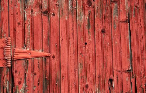 Rugged Old Red Wooden Door with Hinge Detail