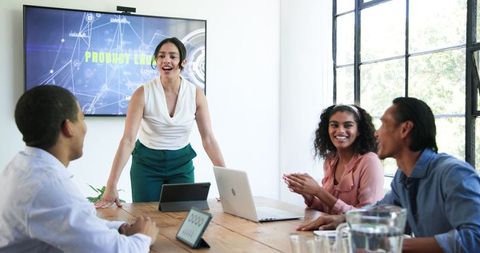 Diverse Team Celebrating in Modern Office Meeting
