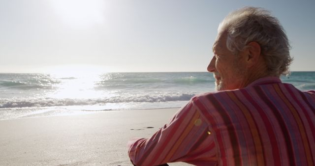 Elderly Man Contemplating Ocean at Sandy Beach During Sunset - Download Free Stock Images Pikwizard.com