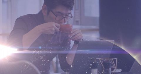 Asian Professional Relaxing with Coffee at Modern Workspace