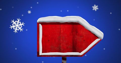 Red Wooden Signpost With Snow and Falling Snowflakes