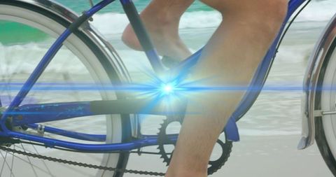 Radiant Cyclist Pedaling Along Beach with Light Overlay