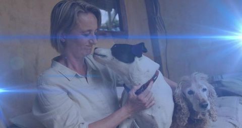 Woman cherishing dogs in cozy rustic living room