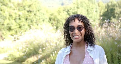 Smiling Woman Enjoying Sunny Day in Nature