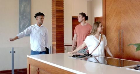 Friends Cheerfully Chatting in Modern Kitchen