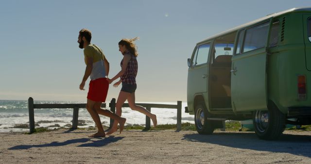 Couple holding hands and running towards beach. Van at the beach on a sunny day 4k