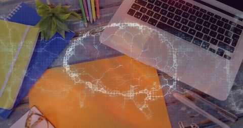 Creative workspace with laptop and brain network overlay concept