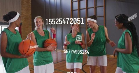 Joyful Female Basketball Team Sharing a Laugh in Gym