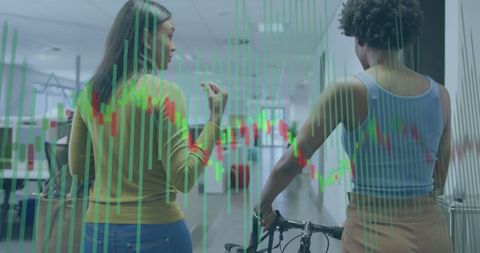 Diverse Professional Women Analyzing Financial Data in Modern Office