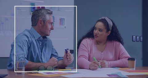 Creative Professionals Collaborating on Color Swatches in Modern Office