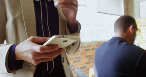 Businesswoman Holding Smartphone in Modern Office Building - Download Free Stock Images Pikwizard.com