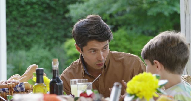 Father and Son Enjoying Outdoor Family Dinner - Download Free Stock Images Pikwizard.com