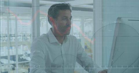 Businessman analyzing financial data on computer at office