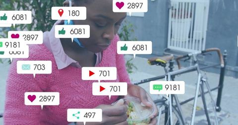 Young woman eating salad on urban sidewalk while social media notifications floating