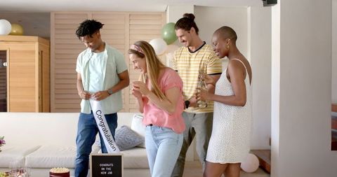 Friends celebrating new job at home with cake