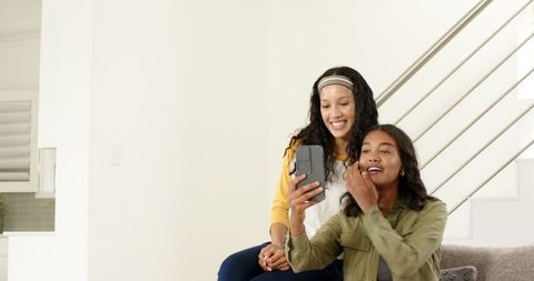 Mother and daughter sharing joyful moments reading letters together