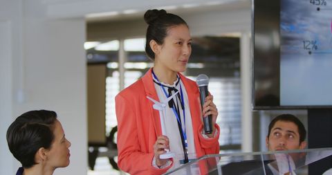 Asian Businesswoman Presenting on Sustainable Energy at Conference