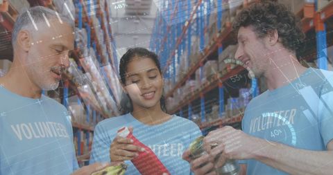 Smiling Volunteers Collaborating in Charity Warehouse with Data Overlay - Download Free Stock Images Pikwizard.com