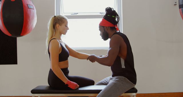 Boxing Trainer Helping Female Boxer with Hand Wraps in Gym - Download Free Stock Images Pikwizard.com