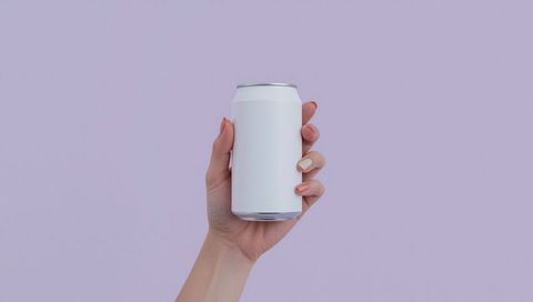 Hand Holding Blank White Can Against Pastel Purple Background