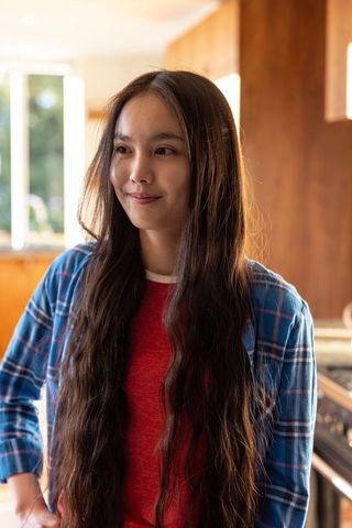 Young Woman Contemplating in Warm Kitchen Atmosphere