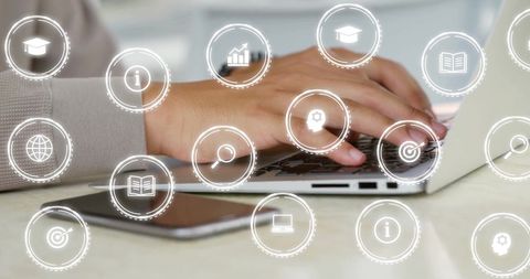 Businessman Typing on Laptop with Digital Overlay in Modern Office