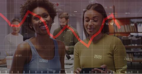 Businesswomen Analyzing Financial Graph Data