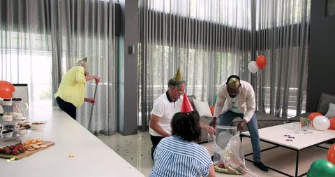 Diverse Colleagues Cleaning After Office Celebration