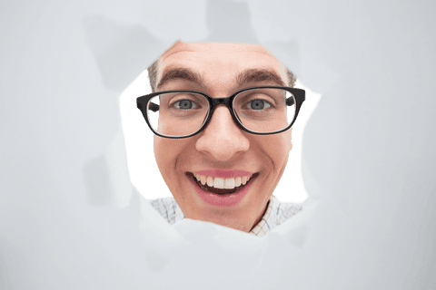 geeky man smiling through torn paper with transparent background - Download Free Stock Videos Pikwizard.com