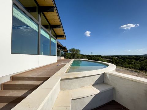Modern Home with Infinity Pool Overlooks Stunning Hillside