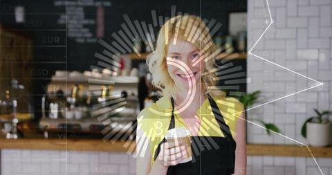 Smiling barista holding to-go cup behind cozy cafe counter with espresso machine