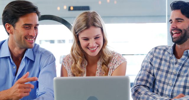 Smiling Colleagues Working Together on Laptop in Modern Office - Download Free Stock Images Pikwizard.com