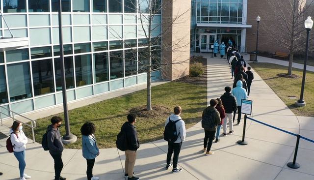 Students queuing outside campus health clinic for covid vaccination and testing line