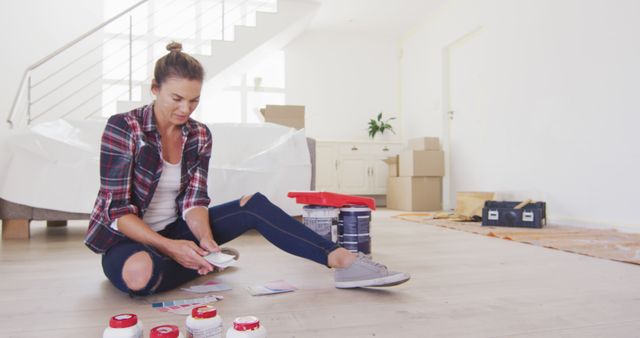 Woman Choosing Paint Colors for Home Renovation in Living Room - Download Free Stock Images Pikwizard.com