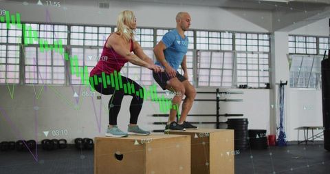 Partners performing box jumps with financial chart overlay in gym for fitness analytics