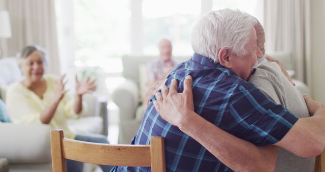 Senior Man Embracing Friend in Community Room with Applauding Audience - Download Free Stock Images Pikwizard.com