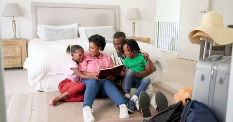 African American Family Sharing Happy Moments in Bedroom
