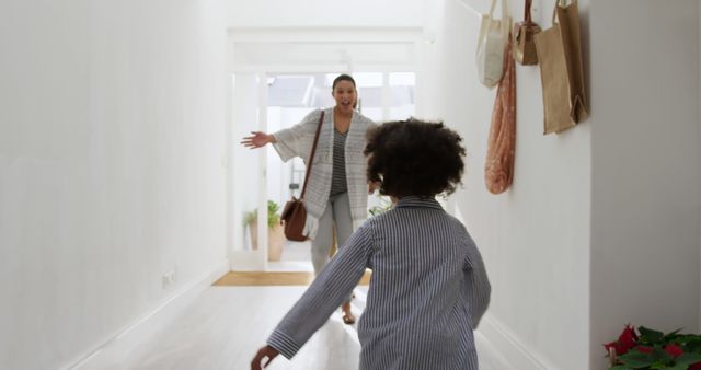 Happy Mother Greeting Daughter in Bright Hallway - Download Free Stock Images Pikwizard.com