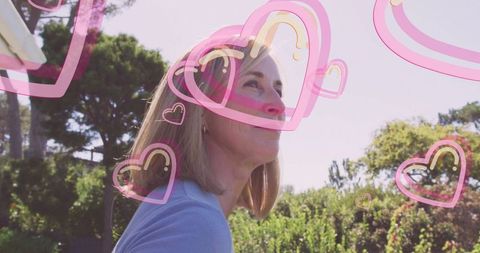 Woman in Garden Surrounded by Heart Overlays Embracing Serenity