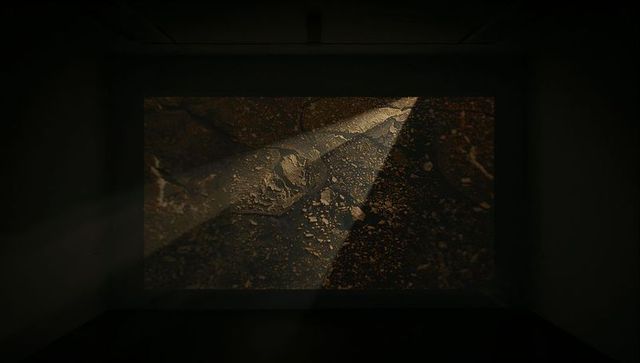 Minimalistic digital projection in dark gallery space