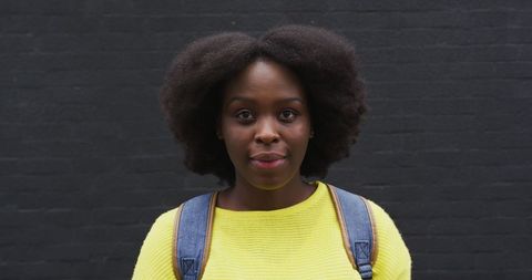 Confident African American Woman Smiling Against Dark Background