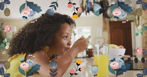 Joyful Child Eating Breakfast Surrounded by Floral Illustrations