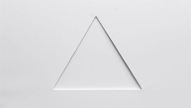 Minimal white paper triangle cutout with lifted edge for clean design background