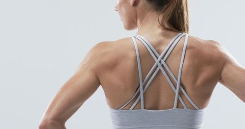 Athletic Woman Exhibiting Toned Back Muscles in Sports Bra